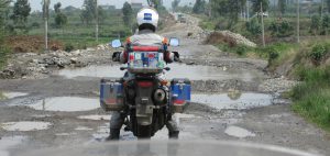 motorbike avoids pothole overwhelm